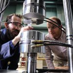 Two scientists look at machine