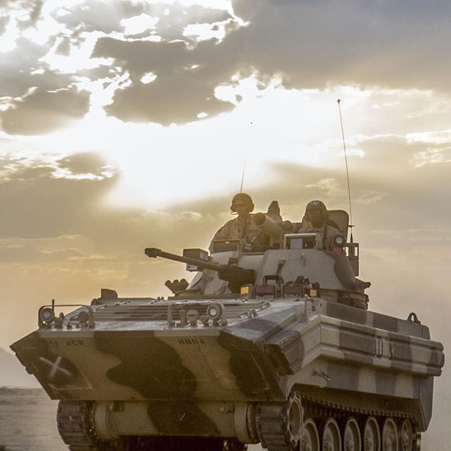 tank driving thorough desert.