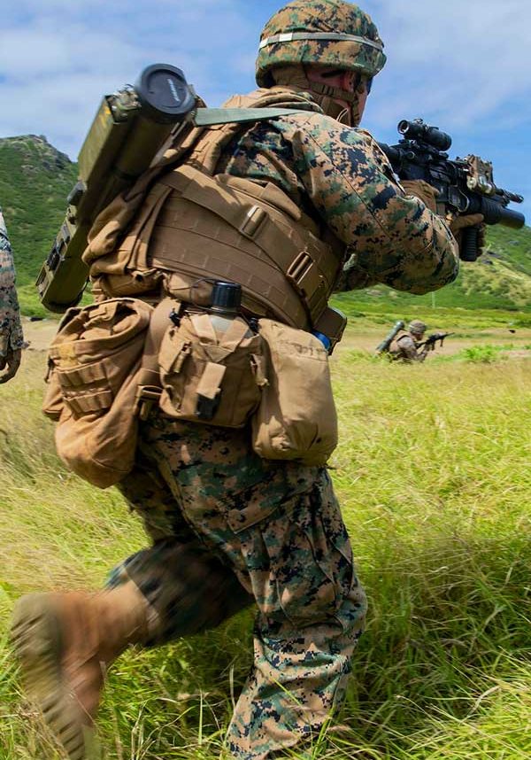 soldier running through grass