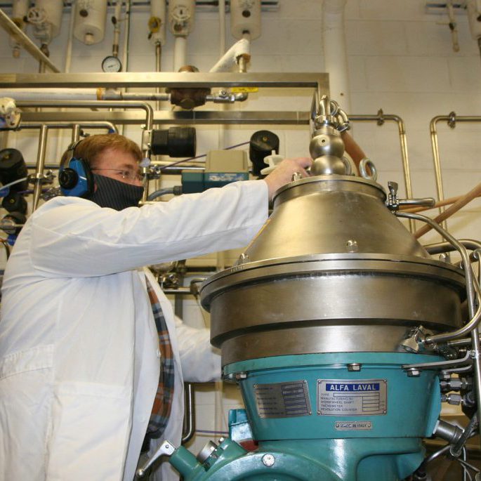 Joe Kragl, a Center biologist, operates a centrifuge in the extraction phase.